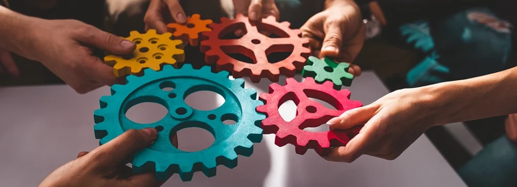 An image of interlocking cogs symbolizing collaboration and integration between Estatesearch and Estateably.